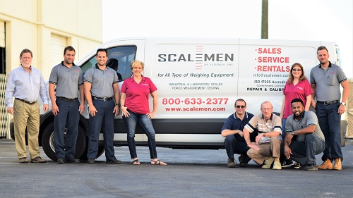 Scalemen of Florida employees in front of a service vehicle